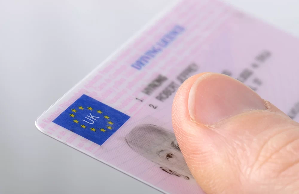 A checklist of essential eligibility requirements for how to hire a van, including age, valid driving licence, and insurance documents at a rental office.