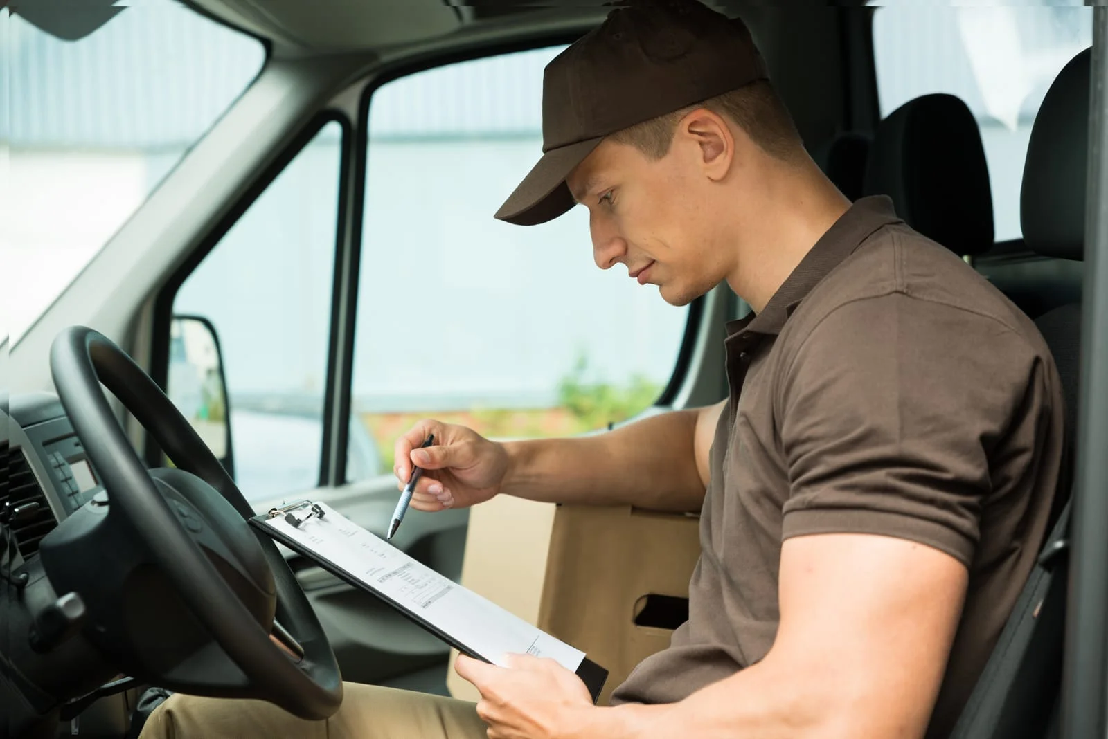 Driver checking a list before a one-off job with a hire van