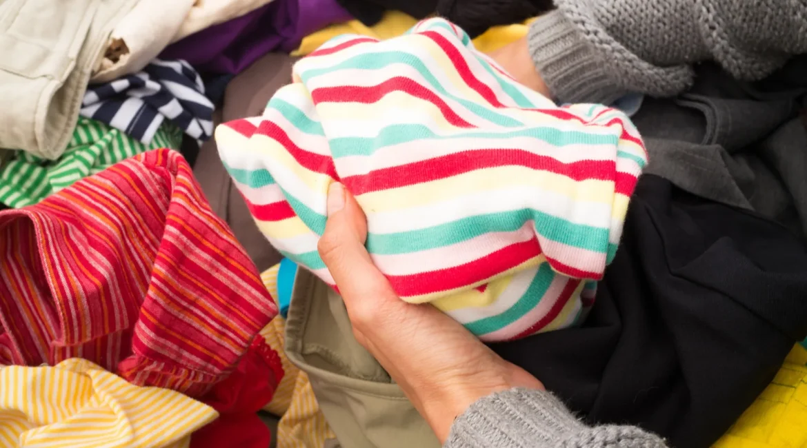 Donated clothes sorted on a table, the kind of load jumble sale van hire moves to the hall