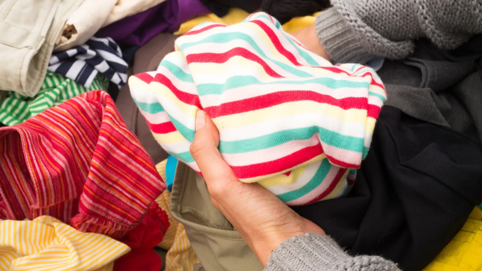 Donated clothes sorted on a table, the kind of load jumble sale van hire moves to the hall