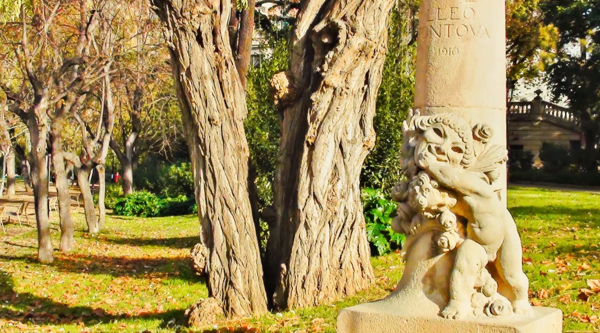 Stone statue on a plinth in an autumn garden, a heavy piece when moving garden statues