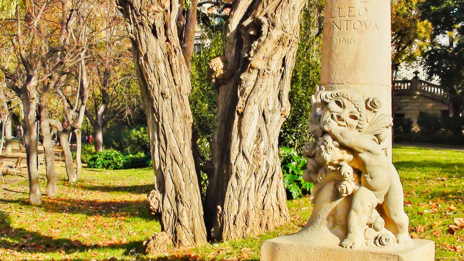 Stone statue on a plinth in an autumn garden, a heavy piece when moving garden statues